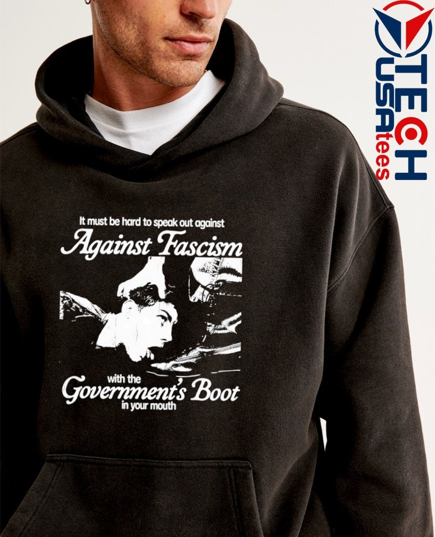 It must be hard to speak out against against fascism with the Government’s Boot in your mouth shirt